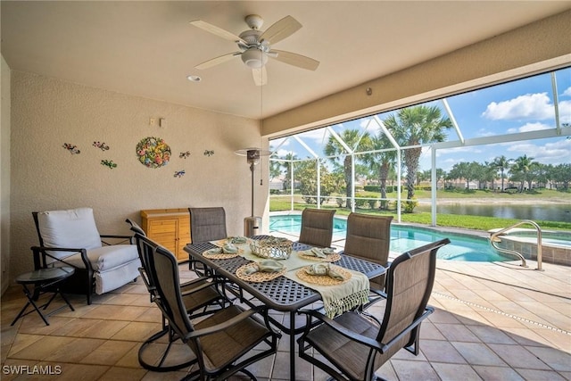 8629 Julia Ln, Naples, FL 34114 - view of patio featuring a water view, a pool with connected hot tub, a ceiling fan, outdoor dining space, and a lanai