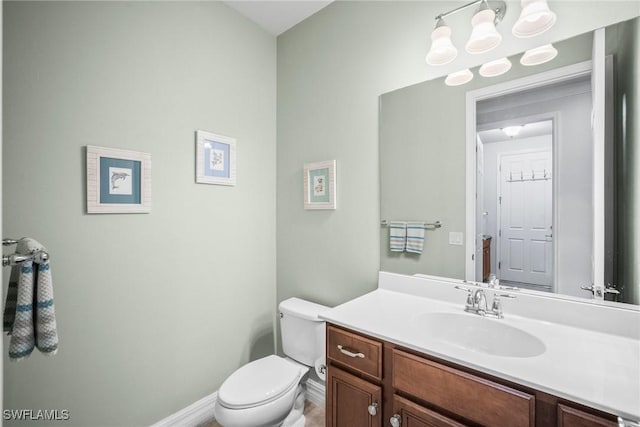 8629 Julia Ln, Naples, FL 34114 - half bathroom featuring toilet, vanity, and baseboards