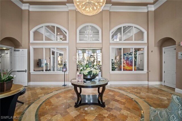 8629 Julia Ln, Naples, FL 34114 - interior space featuring crown molding, a notable chandelier, baseboards, and a towering ceiling