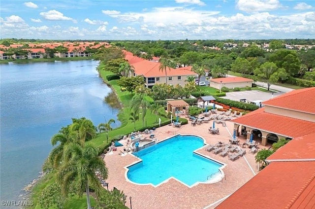 pool featuring a patio and a water view