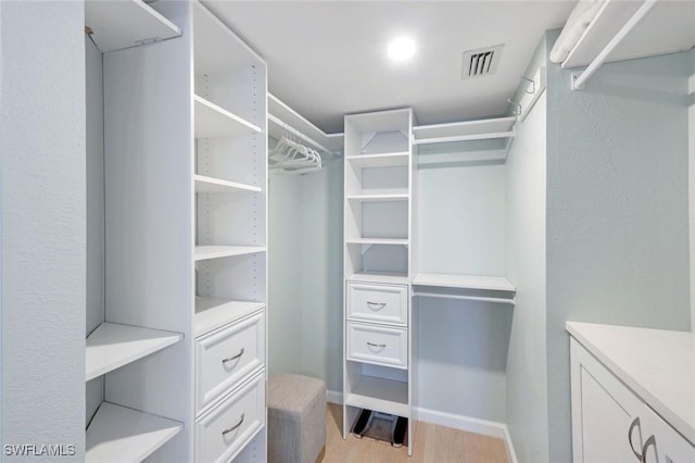 walk in closet featuring light wood-style floors and visible vents