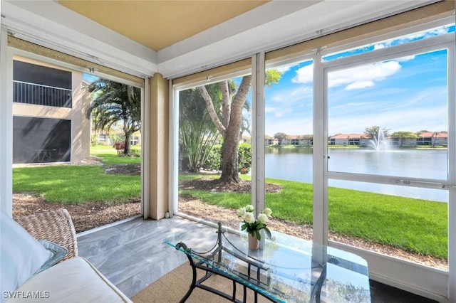 unfurnished sunroom featuring a water view