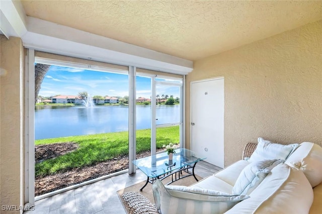 sunroom / solarium with a water view