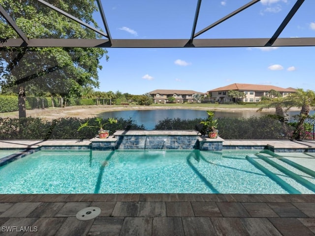 outdoor pool featuring a water view and glass enclosure
