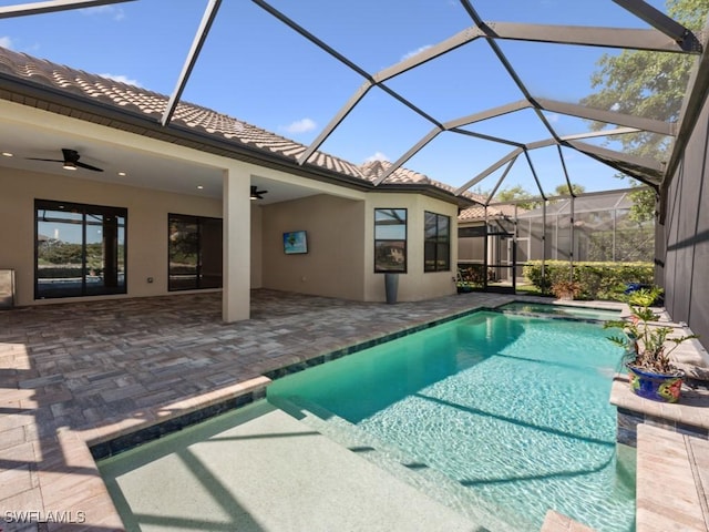 outdoor pool with a patio area and ceiling fan