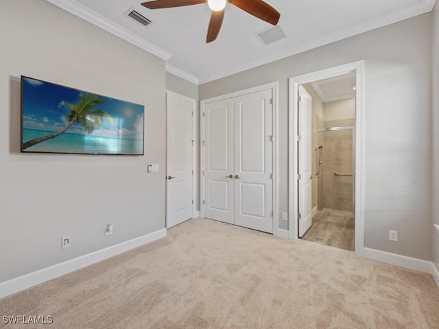 unfurnished bedroom with crown molding, a closet, baseboards, and carpet