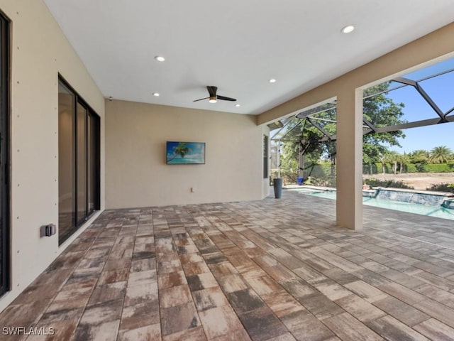 view of patio / terrace featuring an outdoor pool, a ceiling fan, and glass enclosure