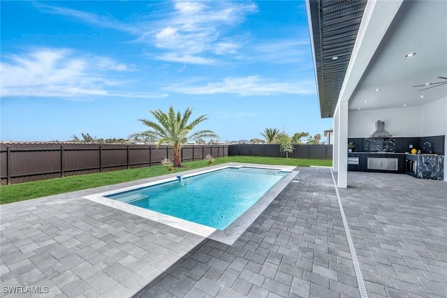 1041 Embers Pkwy W, Cape Coral, FL 33993 - view of pool with an outdoor kitchen, a fenced in pool, a fenced backyard, a patio, and a lawn