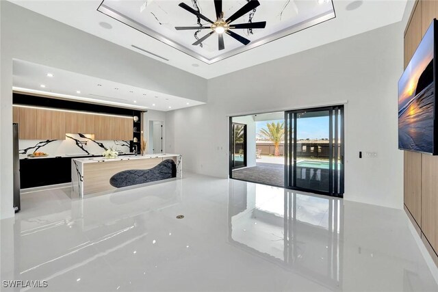 1041 Embers Pkwy W, Cape Coral, FL 33993 - unfurnished bedroom featuring a raised ceiling, a towering ceiling, access to outside, and recessed lighting