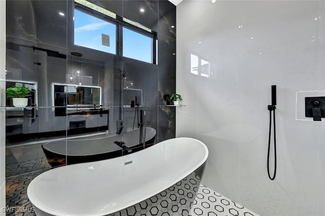 1041 Embers Pkwy W, Cape Coral, FL 33993 - bathroom with a soaking tub and tile walls