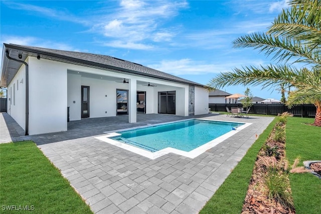 1041 Embers Pkwy W, Cape Coral, FL 33993 - view of swimming pool featuring fence, a patio, a fenced in pool, a ceiling fan, and a lawn