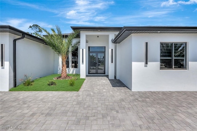 1041 Embers Pkwy W, Cape Coral, FL 33993 - doorway to property featuring stucco siding and french doors