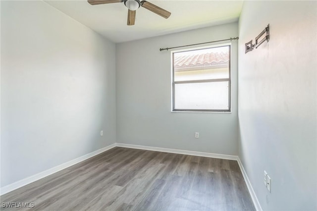 unfurnished room featuring baseboards, a ceiling fan, and wood finished floors