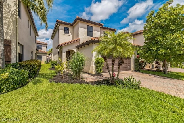 view of front of home with a tiled roof, a garage, stucco siding, a front yard, and driveway