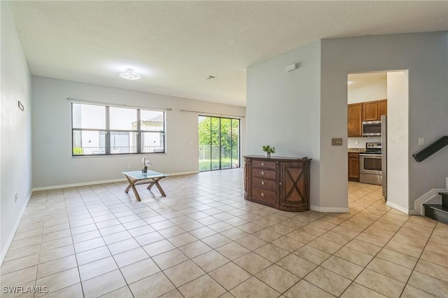 living room featuring light tile patterned floors and baseboards