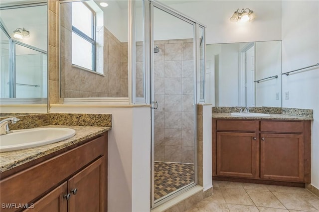 full bathroom with a sink, tile patterned flooring, two vanities, and a stall shower