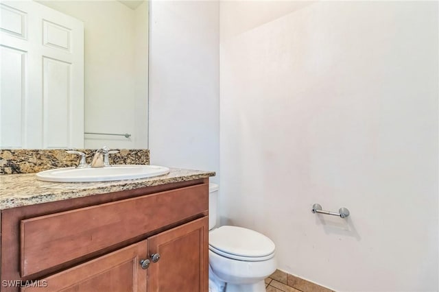 bathroom with tile patterned floors, toilet, and vanity