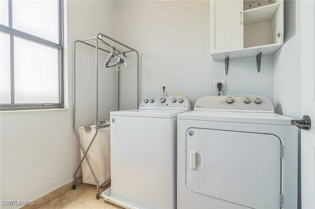 laundry area featuring baseboards and washing machine and clothes dryer