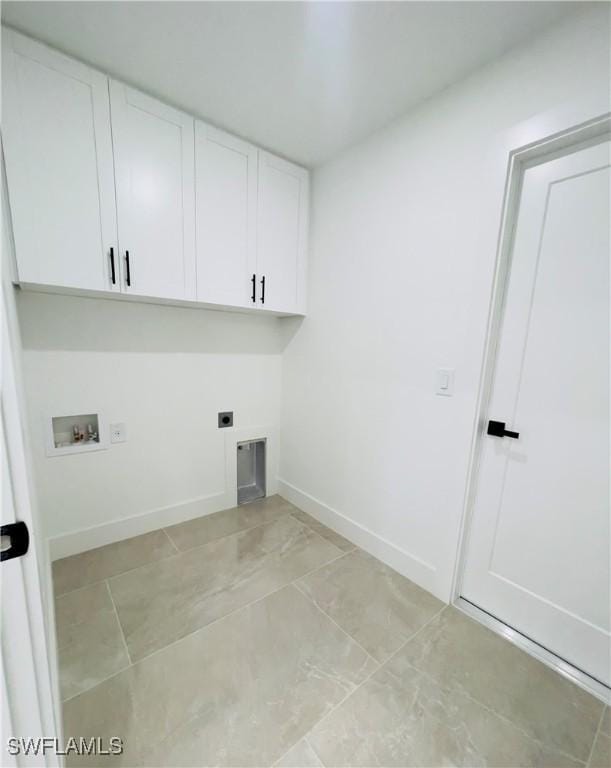 856 Jaguar Blvd, Lehigh Acres, FL 33974 - washroom featuring washer hookup, cabinet space, baseboards, and electric dryer hookup