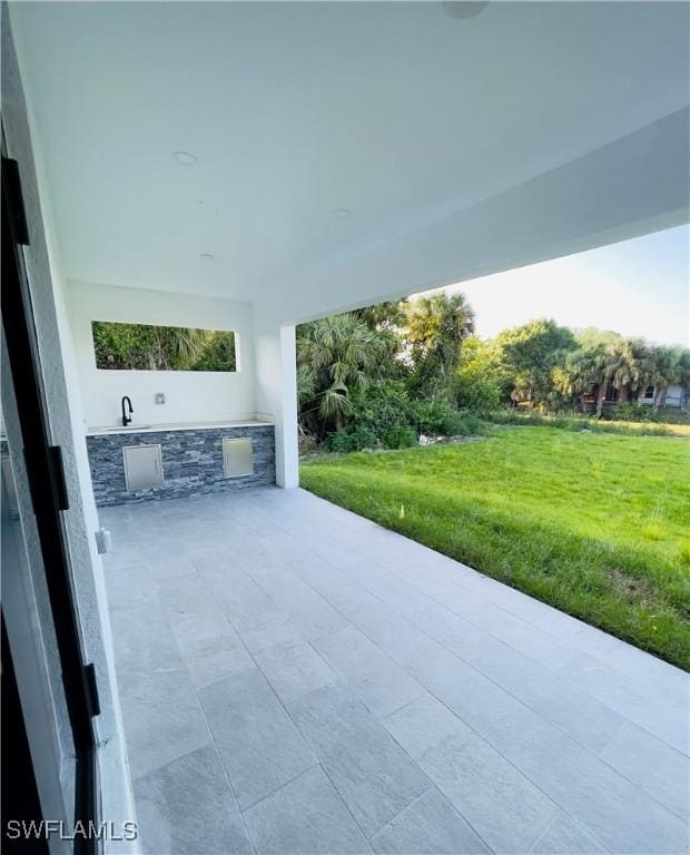 856 Jaguar Blvd, Lehigh Acres, FL 33974 - view of patio featuring an outdoor kitchen
