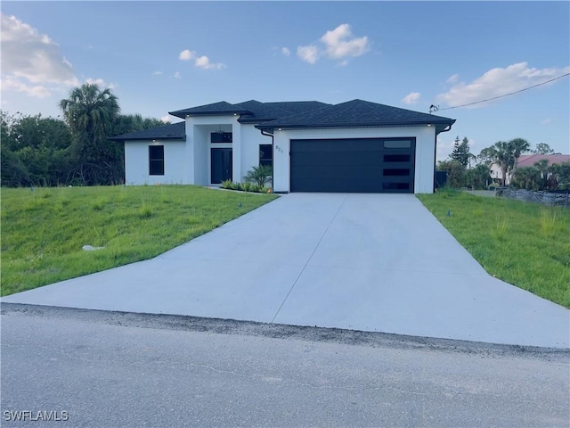 856 Jaguar Blvd, Lehigh Acres, FL 33974 - view of front of home featuring driveway, a front yard, an attached garage, and stucco siding