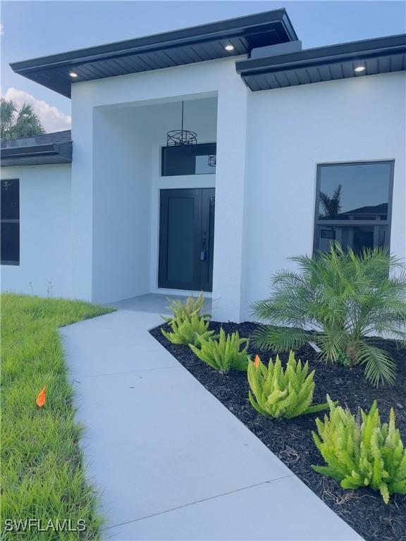 856 Jaguar Blvd, Lehigh Acres, FL 33974 - entrance to property featuring stucco siding