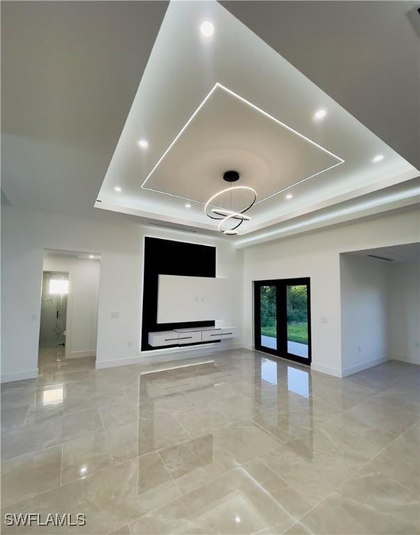 856 Jaguar Blvd, Lehigh Acres, FL 33974 - unfurnished living room with baseboards, marble finish floor, a tray ceiling, and recessed lighting