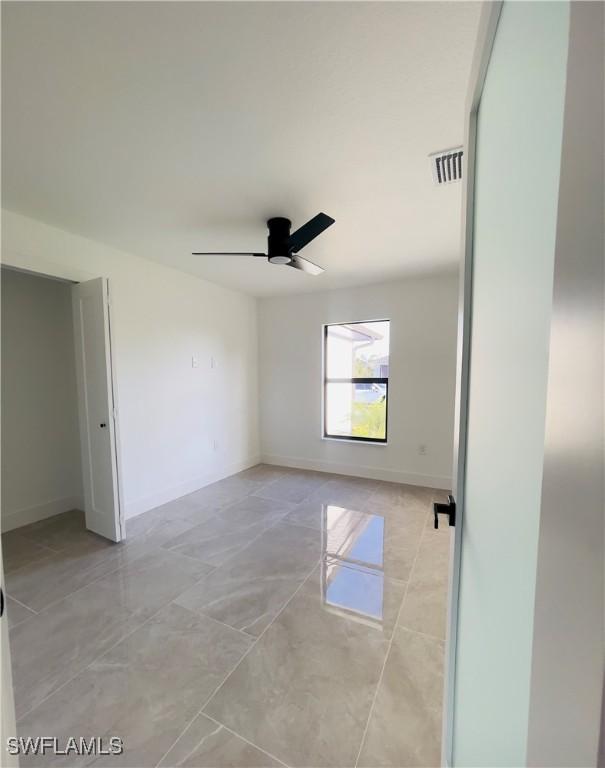 856 Jaguar Blvd, Lehigh Acres, FL 33974 - empty room with baseboards, visible vents, and a ceiling fan
