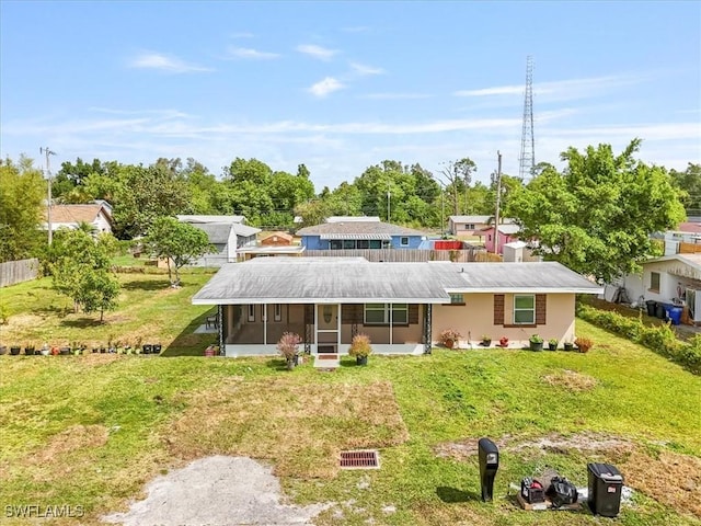 48 Victoria Dr, North Fort Myers, FL 33917 - back of property with a sunroom, stucco siding, and a lawn