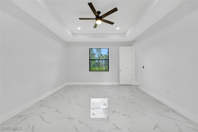 empty room with recessed lighting, baseboards, marble finish floor, a raised ceiling, and ceiling fan