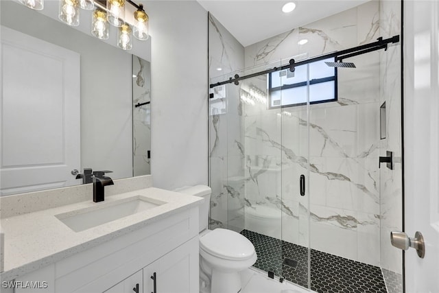 full bath featuring a marble finish shower, marble finish floor, toilet, and vanity