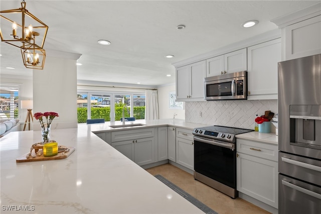 kitchen featuring backsplash, a sink, appliances with stainless steel finishes, and a healthy amount of sunlight