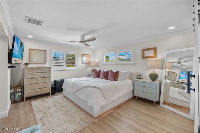 bedroom with recessed lighting, visible vents, light wood-style floors, and crown molding
