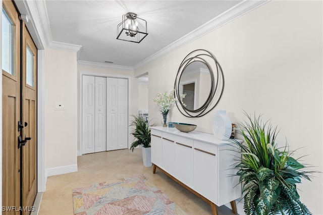 entryway featuring baseboards, an inviting chandelier, ornamental molding, and light tile patterned floors
