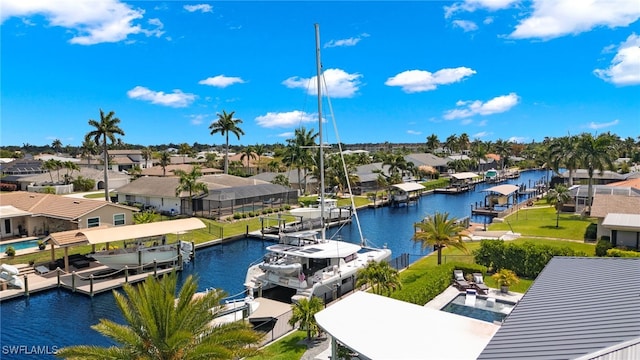 birds eye view of property with a residential view and a water view