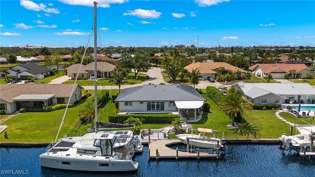 birds eye view of property with a water view and a residential view