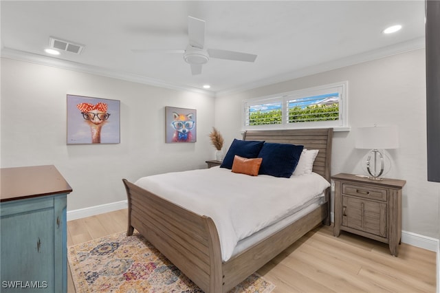 bedroom with light wood-type flooring, baseboards, visible vents, and crown molding