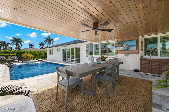 view of pool featuring outdoor dining space, a ceiling fan, a patio, and a fenced in pool