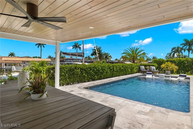 view of swimming pool with a patio, ceiling fan, and a fenced in pool