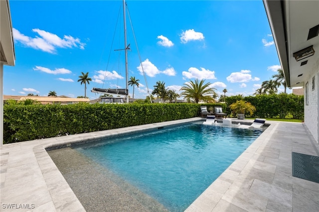 view of swimming pool featuring a patio area and a fenced in pool
