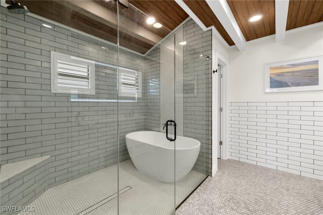 full bathroom with a stall shower, tile patterned floors, beam ceiling, wood ceiling, and tile walls