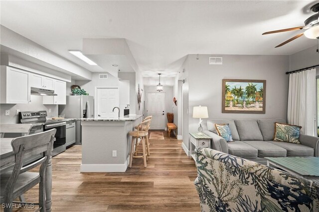 4665 Saint Croix Ln Unit 1525, Naples, FL 34109 - living room featuring visible vents, light wood-style floors, and a ceiling fan