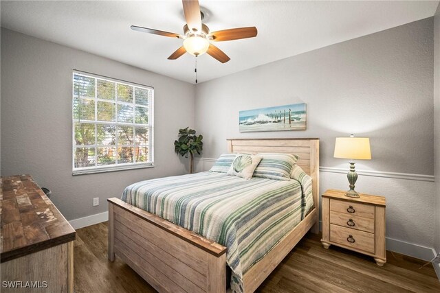 4665 Saint Croix Ln Unit 1525, Naples, FL 34109 - bedroom with dark wood-type flooring, baseboards, and a ceiling fan
