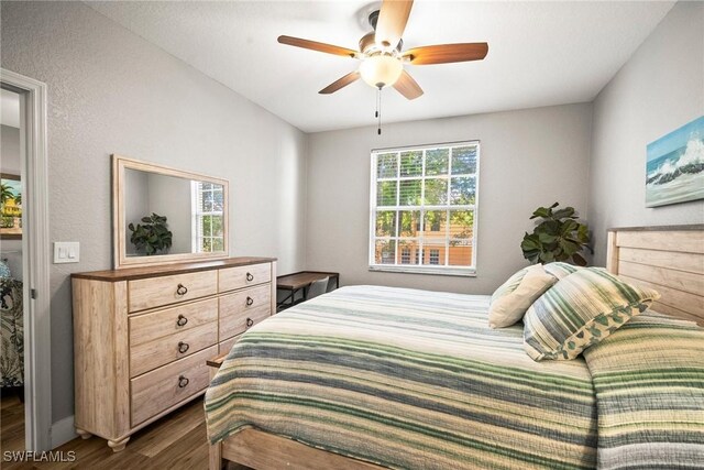 4665 Saint Croix Ln Unit 1525, Naples, FL 34109 - bedroom featuring a ceiling fan and dark wood-style flooring