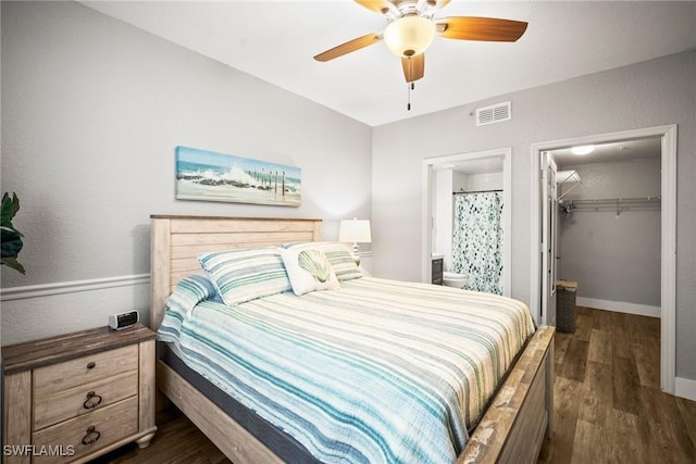 4665 Saint Croix Ln Unit 1525, Naples, FL 34109 - bedroom with a closet, ensuite bathroom, visible vents, dark wood-type flooring, and a walk in closet