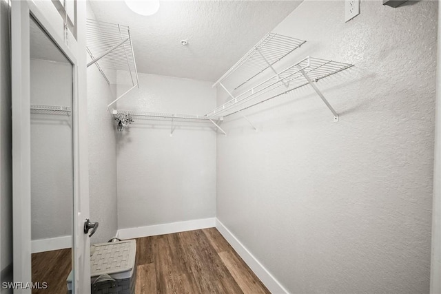 4665 Saint Croix Ln Unit 1525, Naples, FL 34109 - walk in closet with wood finished floors