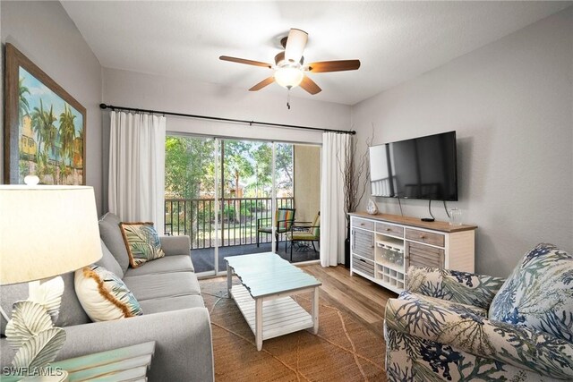 4665 Saint Croix Ln Unit 1525, Naples, FL 34109 - living area featuring a ceiling fan and wood finished floors