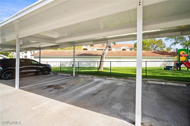 4665 Saint Croix Ln Unit 1525, Naples, FL 34109 - covered parking lot featuring playground community and fence