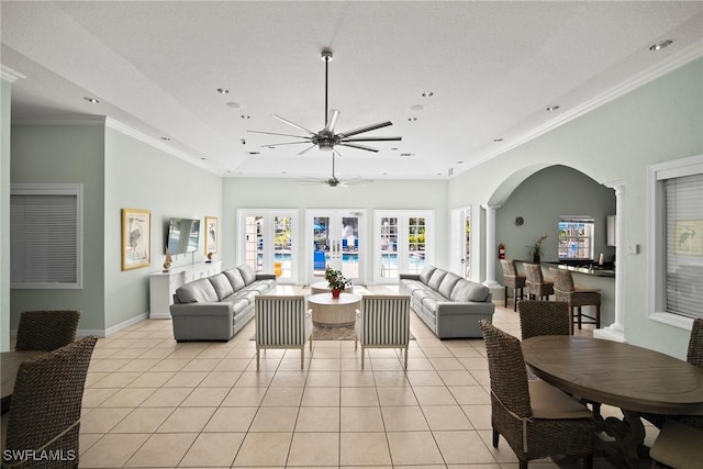 4665 Saint Croix Ln Unit 1525, Naples, FL 34109 - living room featuring arched walkways, ceiling fan, light tile patterned floors, and plenty of natural light