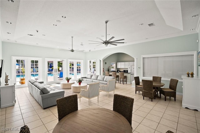4665 Saint Croix Ln Unit 1525, Naples, FL 34109 - living room featuring french doors, light tile patterned flooring, arched walkways, and a tray ceiling